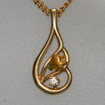 Nugget and diamond `Swirl` yellow gold pendant.